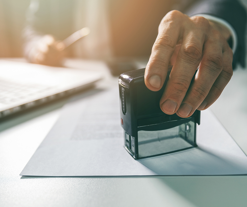 person stamping a document